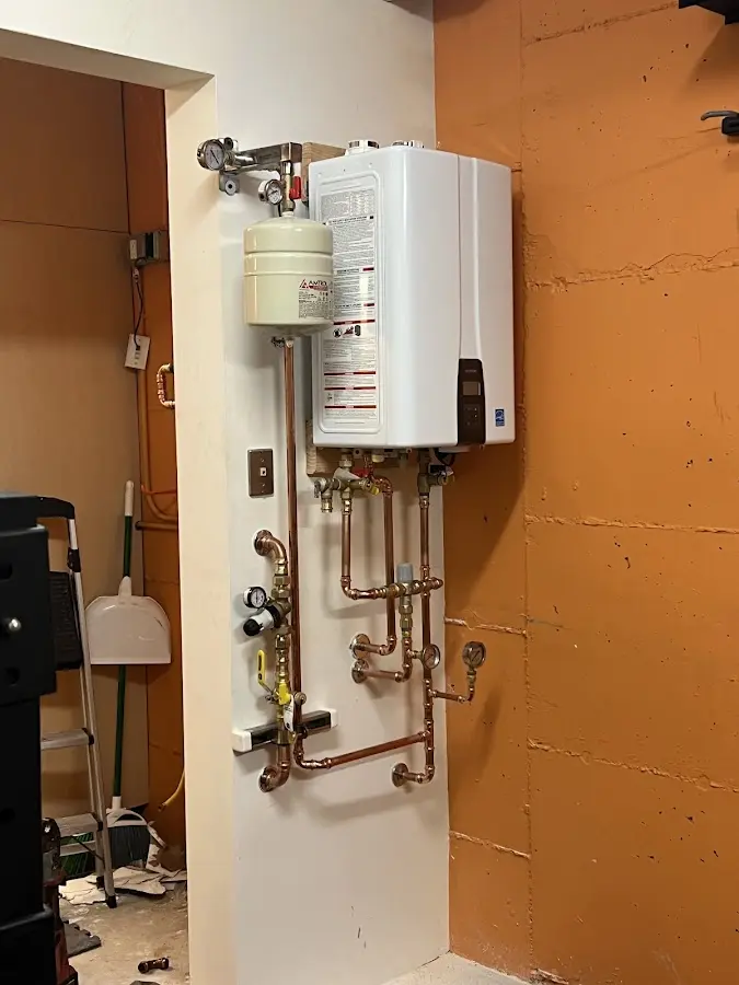 Plumbing technician inspecting water heater connections in Fountain Hills
